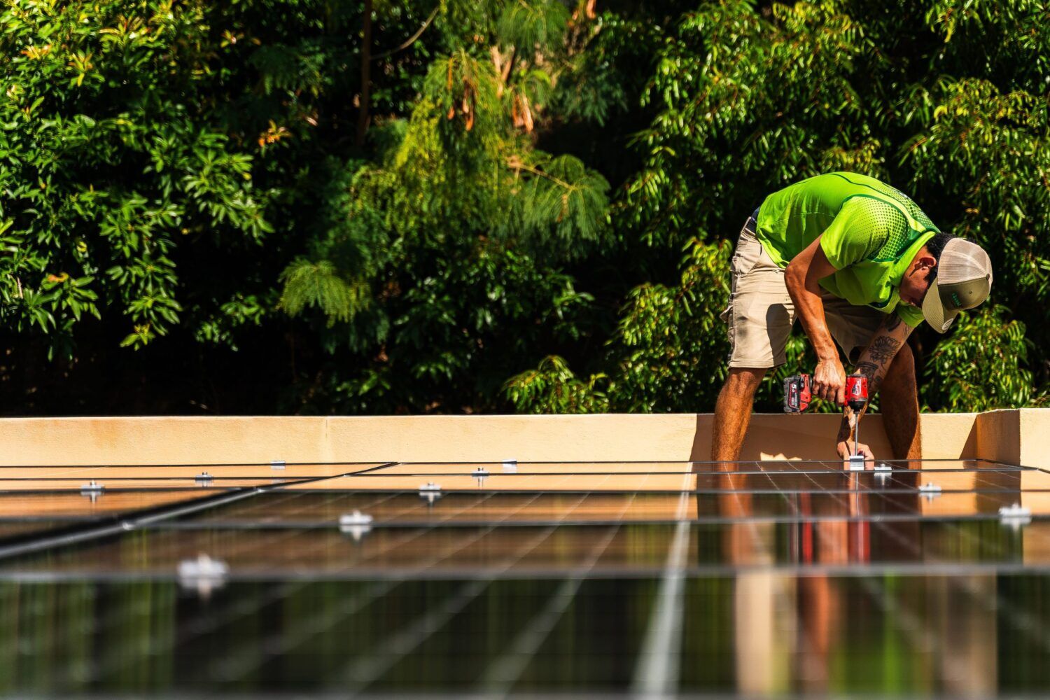 Green Energy Technologies installer securing a solar panel on the roof, ensuring efficient solar energy installation